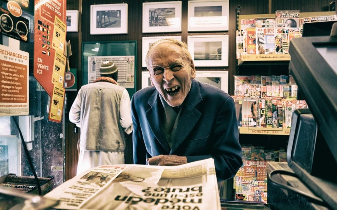 Old man in a book store with a funny face to exemplify Search Engine Optimization Techniques